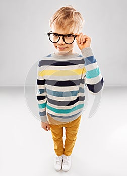 Smiling boy in glasses and striped pullover