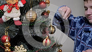 Smiling Boy Hanging Nice Shiny Christmas Tree Toys, Balls on Christmas Tree