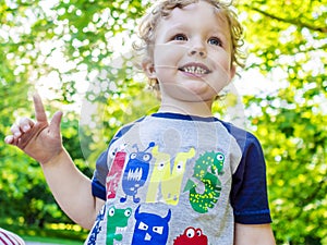 Smiling boy on his walk in summer park