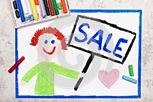 Smiling boy holdilng banner in his hand with word SALE