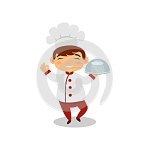 Smiling boy holding dish in hand. Cute kid in chef uniform and hat. Little cook. Future job. Flat vector design