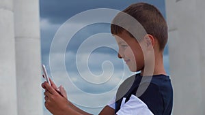 Smiling boy looking at smartphone