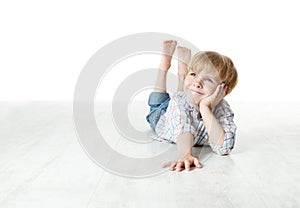 Smiling boy lying down on floor and looking up