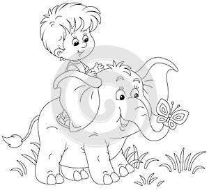 Happy little kid riding on a funny baby elephant
