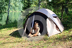 Smiling boy near tent