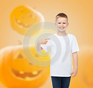 Smiling boy over pumpkins background