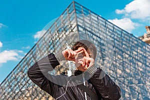 Smiling boy in Paris near the Louvre pyramid