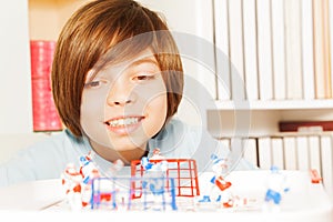 Smiling boy playing ice hockey table board game