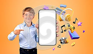 Smiling boy point at mockup smartphone, online shopping and vide