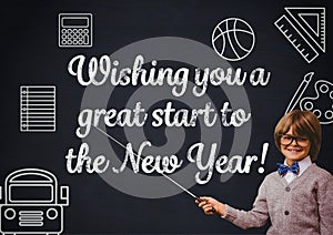 Smiling boy pointing at blackboard with new year greeting quotes