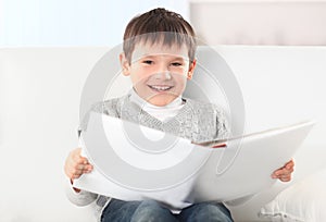Smiling boy reading a book in the nursery.photo with copy space