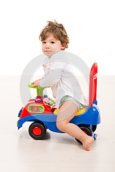 Smiling boy ride a big car toy