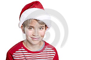 Smiling boy in Santa red hat isolated on white background. Christmas concept.