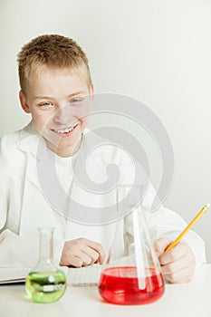Smiling Boy Scientist with Notebook and Beakers