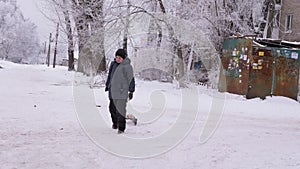 Smiling Boy with Sled Runs Up Snowy Road. Red-Cheeked Child. Frosty Weather. 4K