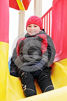 Smiling boy in slide