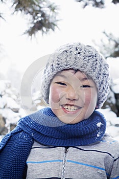 Smiling boy in the snow, portrait