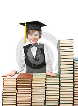 Smiling boy at stacks of old books