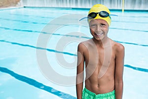 Smiling boy standing near poolside