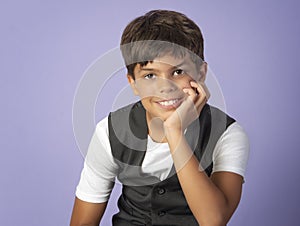 Smiling boy in suit vest and white shirt