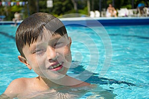 Smiling boy in a swimming pool