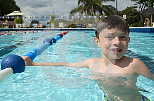 Smiling boy in a swimming pool