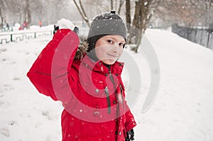 Smiling boy throwing snowball