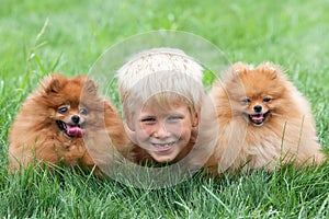 Smiling boy with two dogs