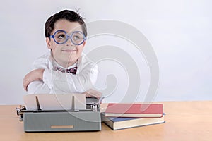 Smiling boy with typewriter