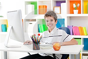 Smiling boy using a computer