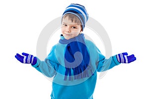 Smiling boy in winter clothes put hand to the sides