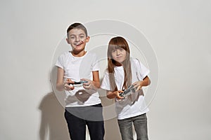 Smiling boy and worried girl play video game