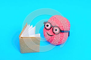 Smiling Brain in Glasses Engaged in Book Reading photo