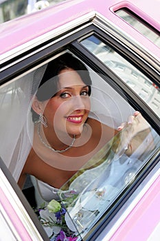 Smiling bride in limousine