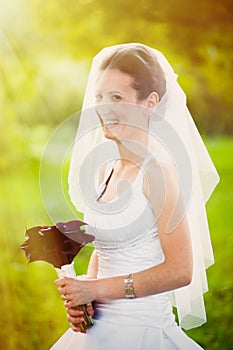 Smiling bride outdoors