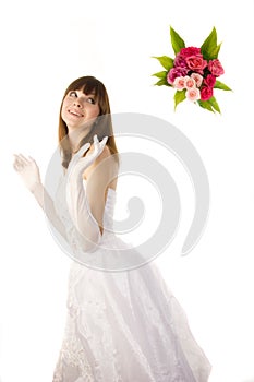 Smiling bride tossing a bouquet.