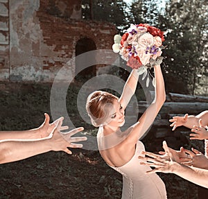 Smiling bride tossing a bouquet for her good friends