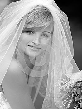 Smiling bride in white wedding dress