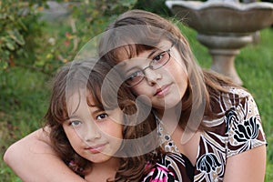 Smiling brown-haired sisters