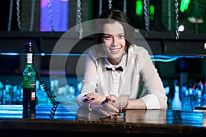 Smiling brunette bartender at nightclub