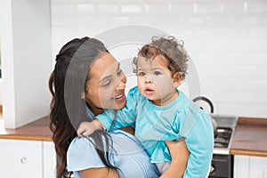 Smiling brunette holding her baby