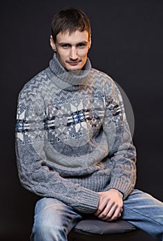 Smiling brunette man wearing knitted sweater