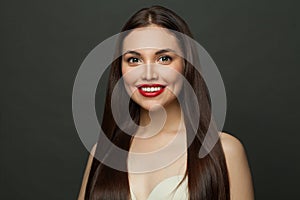 Smiling brunette model long straight hair and cute smile on black background