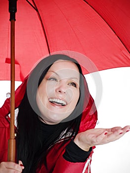 Smiling brunette woman in fall, rainproof clothes