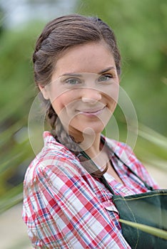 smiling brunette woman gardening