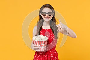 Smiling brunette woman girl in red summer dress, 3d glasses isolated on yellow background. People lifestyle concept