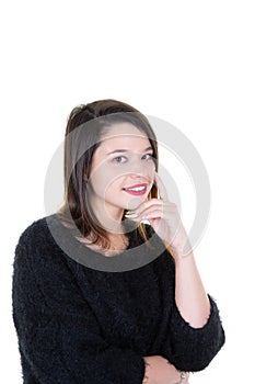 Smiling brunette woman with hand on chin looking at the camera