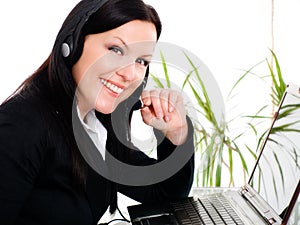 Smiling brunette woman with headphone in office