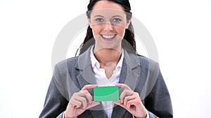 Smiling brunette woman holding a business card