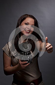 Smiling brunette woman posing thumbs up